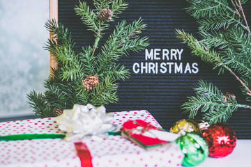 Merry Christmas Text on a Letterboard Surrounded by Christmas Decorations