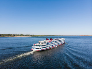 A cruise ship with tourists passes along the Volga downstream towards Astrakhan. Volgograd. Russia