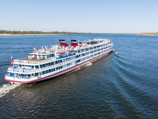 A large cruise ship with tourists on board runs along the Volga downstream towards Astrakhan. Volgograd. Russia