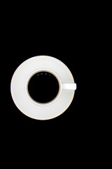 white Cup with black coffee surrounded by roasted coffee beans on a white background. Top view