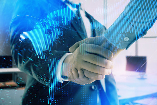 Multi exposure of world map on office background with two businessmen handshake. Concept of international business