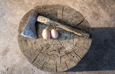 The old axe in the chopping block and eggs