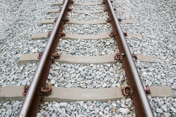 Naklejka premium Old railroad Background. Transportation industry pattern .rust iron railway on cement with gray stone. Concept industry and travel