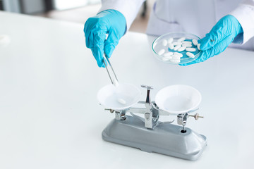 Researchers are weighing tablets in the laboratory.