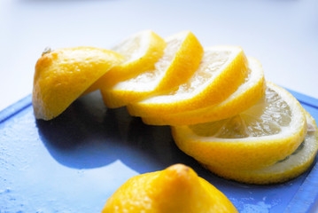 sliced lemon on a blue chopping Board