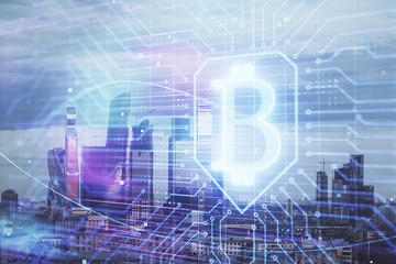 Fototapeta na wymiar Double exposure of bitcoin sign drawing hologram on cityscape background. Concept of crypto economy