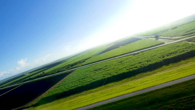 A paramotor pilot making a big turn over a waterway flowing out to Lake Okeechobee