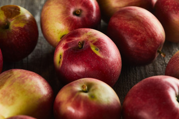 red ripe apples on brown wooden surface
