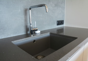 Fototapeta premium Modern kitchen chrome faucet and ceramic kitchen sink.