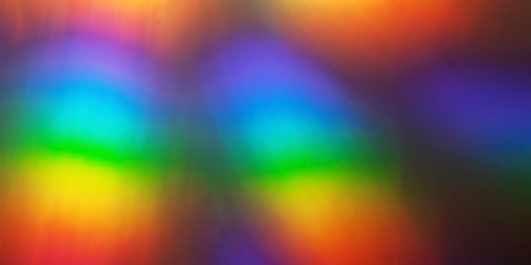 Rainbow abstract glowing light colorful defocused background.