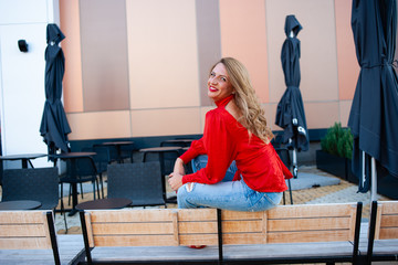 Beautiful young blonde woman posing outdoor on a sunny morning.