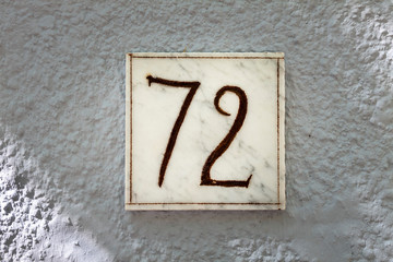 Street number sign on the wall