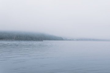 mountain lake in late autumn in the fog