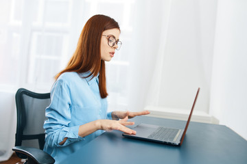 Fototapeta premium young woman working on laptop in office