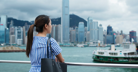 Fototapeta na wymiar Woman look around the beautiful view in Hong Kong