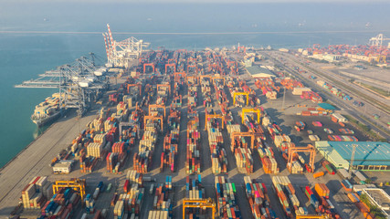 Container ship in export and import business logistics and transportation. Cargo and container box shipping to harbor by crane. Water transport International. Aerial view and top view.