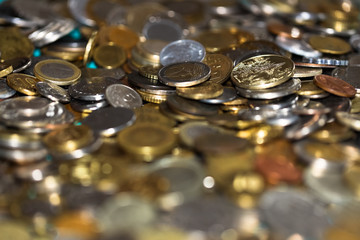 many coins of different countries close-up