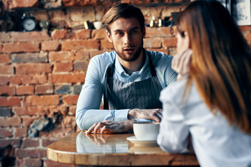 young couple drinking coffee in cafe