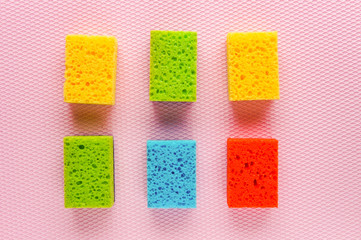 Kitchen cleaning set sponge over pink background