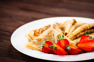 Crepes with cream and strawberries