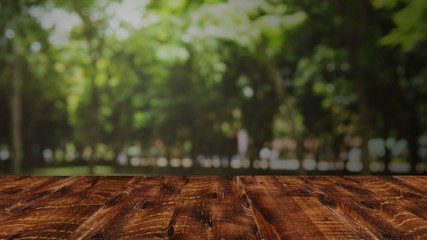 Empty wooden table with blurred green nature background. Mock uf for product display
