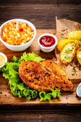 Grilled chicken fillet with baked potatoes and vegetables