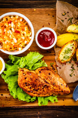 Grilled chicken fillet with baked potatoes and vegetables