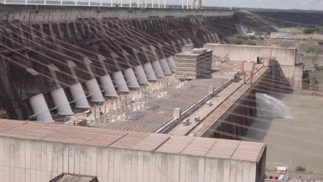 Side panorama of Itaipu dam on river Parana on the border of Brazil and Paraguay. Slow motion