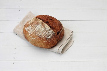 Yeast free, no knead, unleavened healthy organic rye wheat homemade bread on a white wooden background. Top view, place for text.