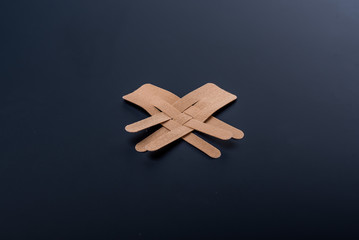 Obraz premium Tapes for face beautifully lie on a black background. Kineziotape for rejuvenation. Kineziology to help fight wrinkles. Surgical rejuvenation.