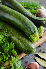 Fresh organic zucchini, garlic and parsley, herbs and spices.