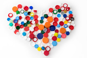 heart made of plastic caps on white