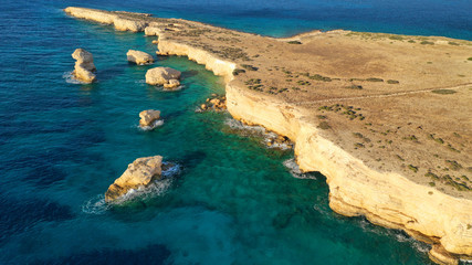 Obraz premium Aerial drone photo of small islet of Glaronisi with paradise emerald clear sea rocky beaches, Koufonisi island, Small Cyclades, Greece