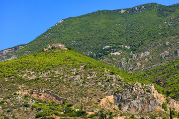 Fototapeta na wymiar A bottom-up view of two monasteries, one male and one female, in Loutraki, Greece.