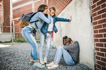 A sad girl intimidation moment on the elementary Age Bullying in Schoolyard