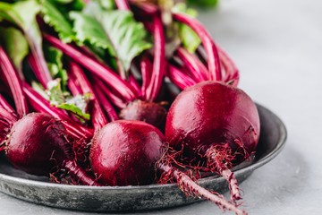 Bunch of fresh raw organic beets with leaves - obrazy, fototapety, plakaty