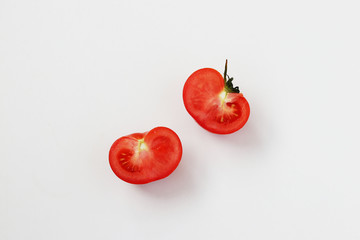 Halves of a tomato isolated on a white background, top view, horizontal orientation, closeup