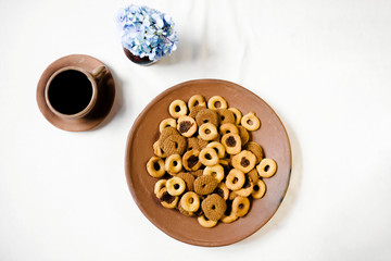Rosquillas, viejitas and rosquetes on a handmade clay plate with a cup of coffee. No people. 