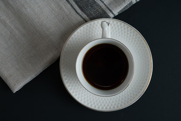 coffee in white cup dark background