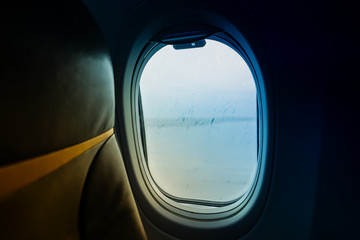 Naklejka premium Raindrops on window glass From Passenger Seat On Airplane
