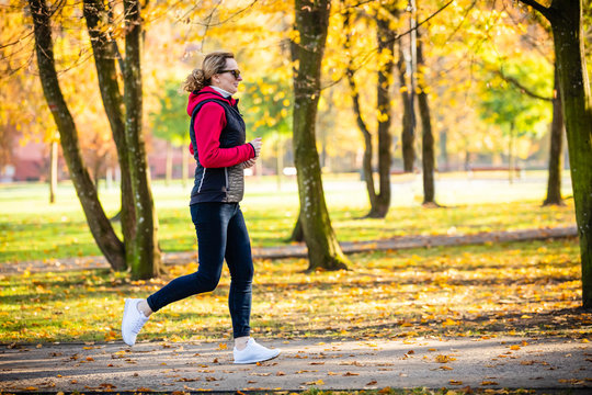 Healthy lifestyle - woman running in city park