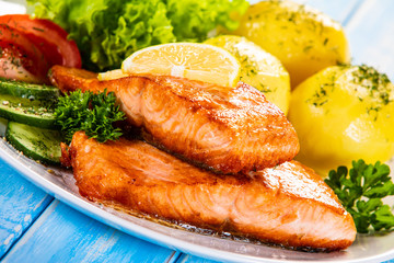 Grilled salmon with boiled potatoes and vegetable salad