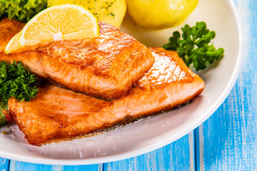 Grilled salmon with boiled potatoes and vegetable salad