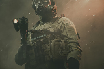 Special force soldier between smoke and dust at battlefield