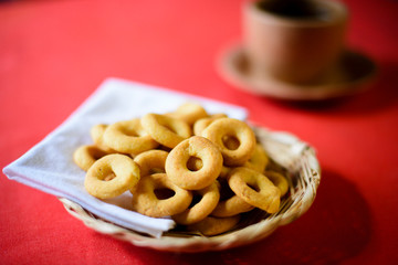 Rosquillas de queso served in a handmade palm tray accompanied by a cup of coffee. Nicaraguan breakfast/snack. No people.