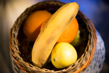 Fruit basket - ripe banana, orange and juicy apples