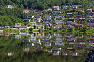 View to the small town Norheimsund. The houses are reflected in the calm water