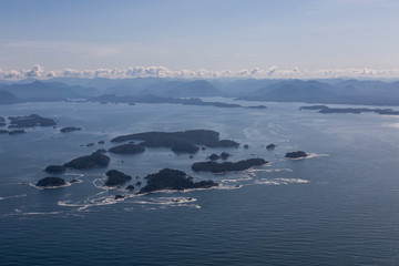 Aerial Landscape View of Beautiful Pacific Ocean Coast with Coastal Mountains at the background during a summer morning. Taken near Tofino and Ucluelet, Vancouver Island, British Columbia, Canada.