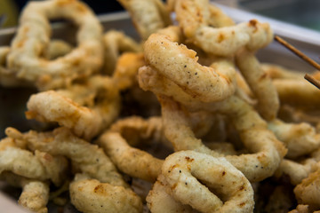 Delicious deep fried rings of squid close up.