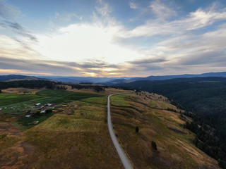 Aerial Panoramic View of a Scenic Highway in the Country Side during a colorful summer sunrise. Taken in the Kootenay, near Rock Creek, British Columbia, Canada.